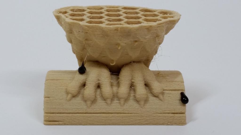 A failed 3D print and tar residue drops