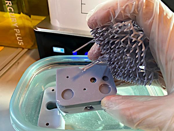 Removing the support material and rinsing the part