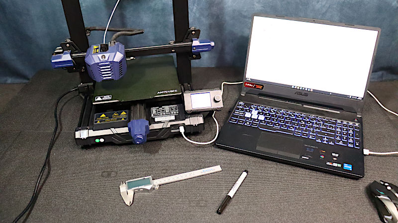 A 3D printer, a laptop, calliper and marker