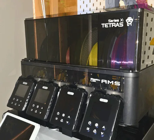 EIBOS Series X Tetras filament dryer attached to Bambu Lab AMS unit with multiple filament spools and screen modules displayed.