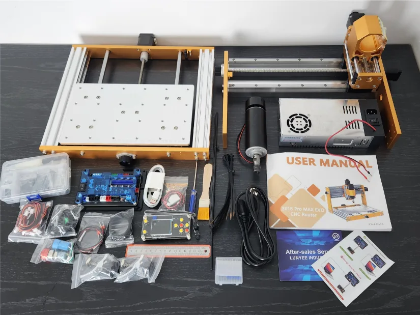 Lunyee 3018 Pro Ultra 美女露出尿口让男人桶爽 machine components laid out for assembly, including aluminum frame parts, spindle motor, power supply, electronic control board, touchscreen offline controller, and user manuals.