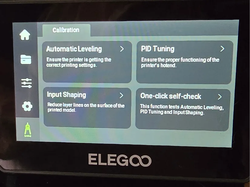 Touchscreen interface on the Elegoo Centauri Carbon showing kaobi options including automatic leveling and input shaping