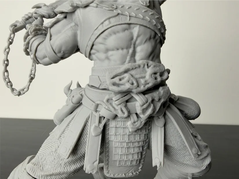 Close-up of Kratos resin print—belt, rope knots, chains, and scale skirt—unpainted gray model from Piocreat HALOT-X1 16K resin 3D printer
