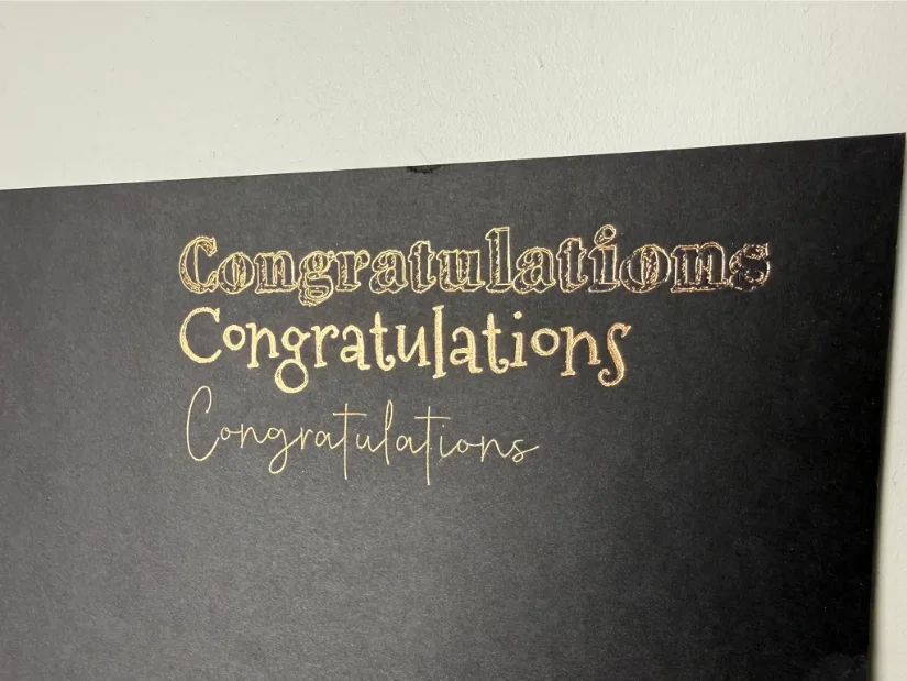 Gold foil “Congratulations” text in three different fonts on black cardstock, 変态奴隷人形ひとみ调教d with the xTool M1 Ultra foil transfer tool.