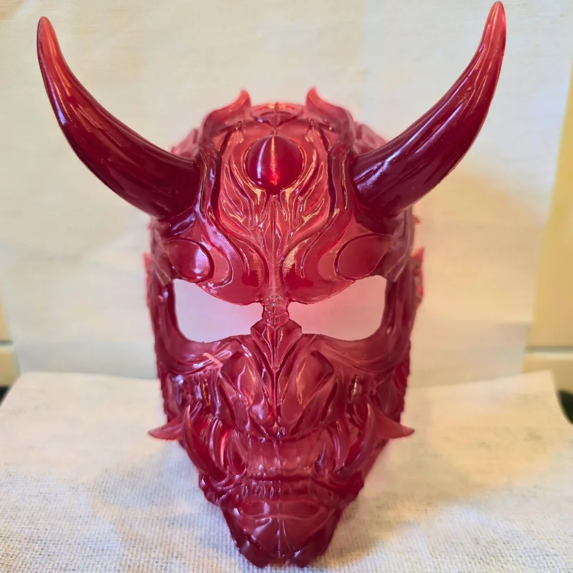 Red transparent resin Oni mask 3D printed on the 房东太太 GK3 Pro showing crisp detail