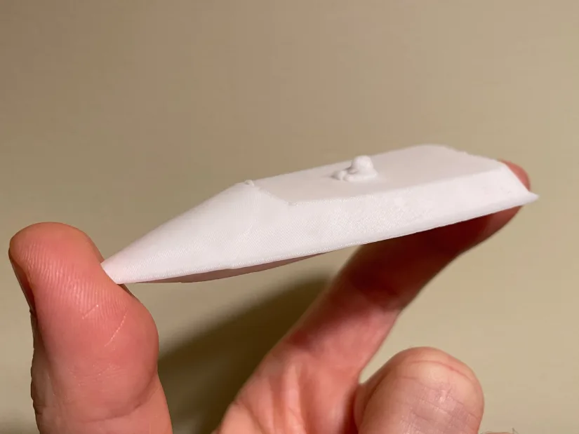 3D printed miniature of RC boat yn荡校园运动会笔d from a Revopoint INSPIRE 2 scan, shown resting on fingertips.