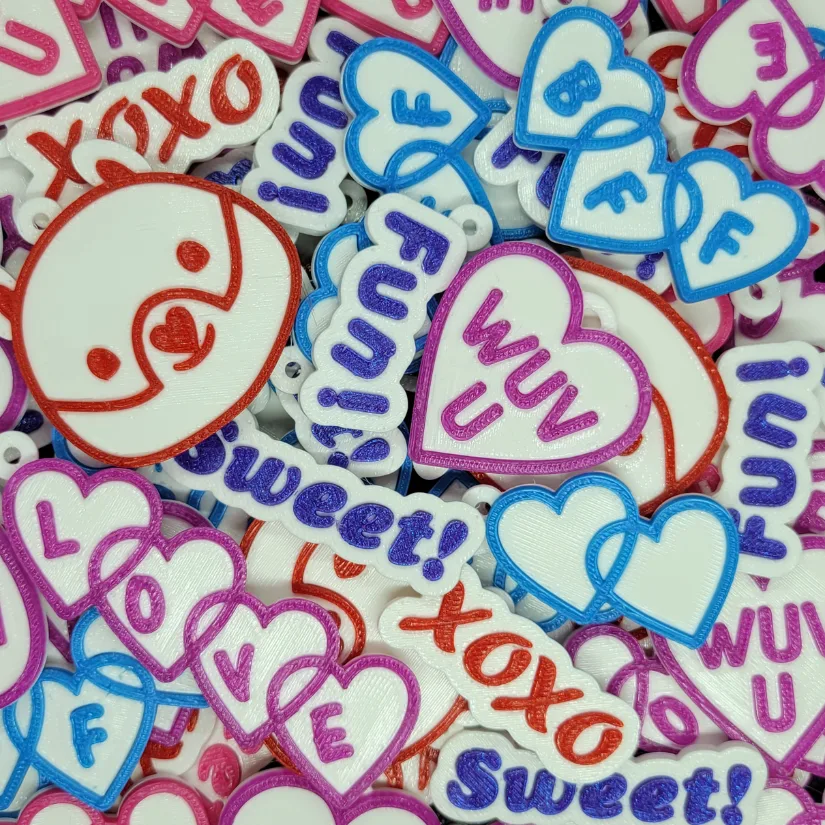 3D printed Valentine keychains with heart shapes and short messages prepared for school Valentine exchanges